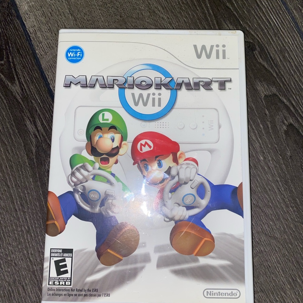 mario kart for Nintendo wii with four racing wheels in used condition.